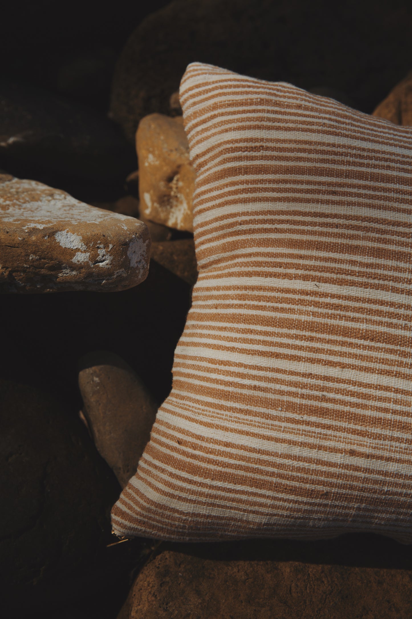 Striped pillow on a stone surface