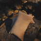 Textured pillow on a rocky surface