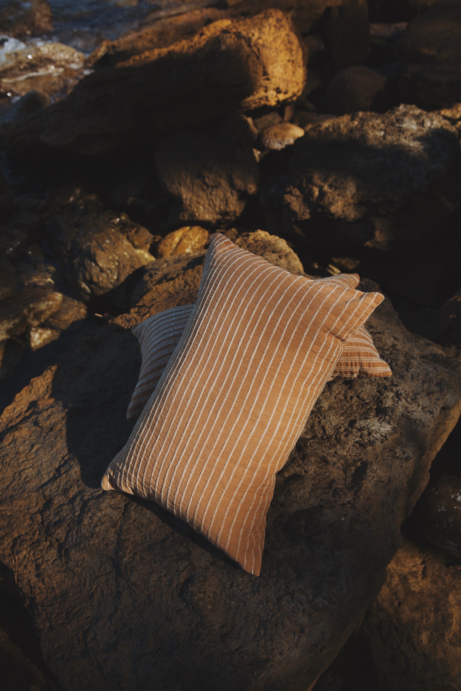 Textured pillow on a rocky surface