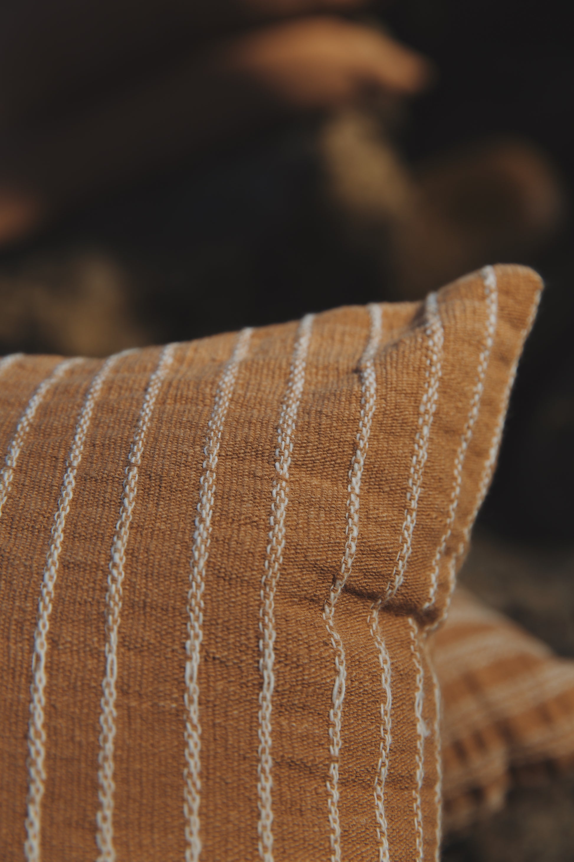 Close-up of a striped pillow with a blurred background