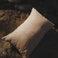 Textured pillow on a rocky surface