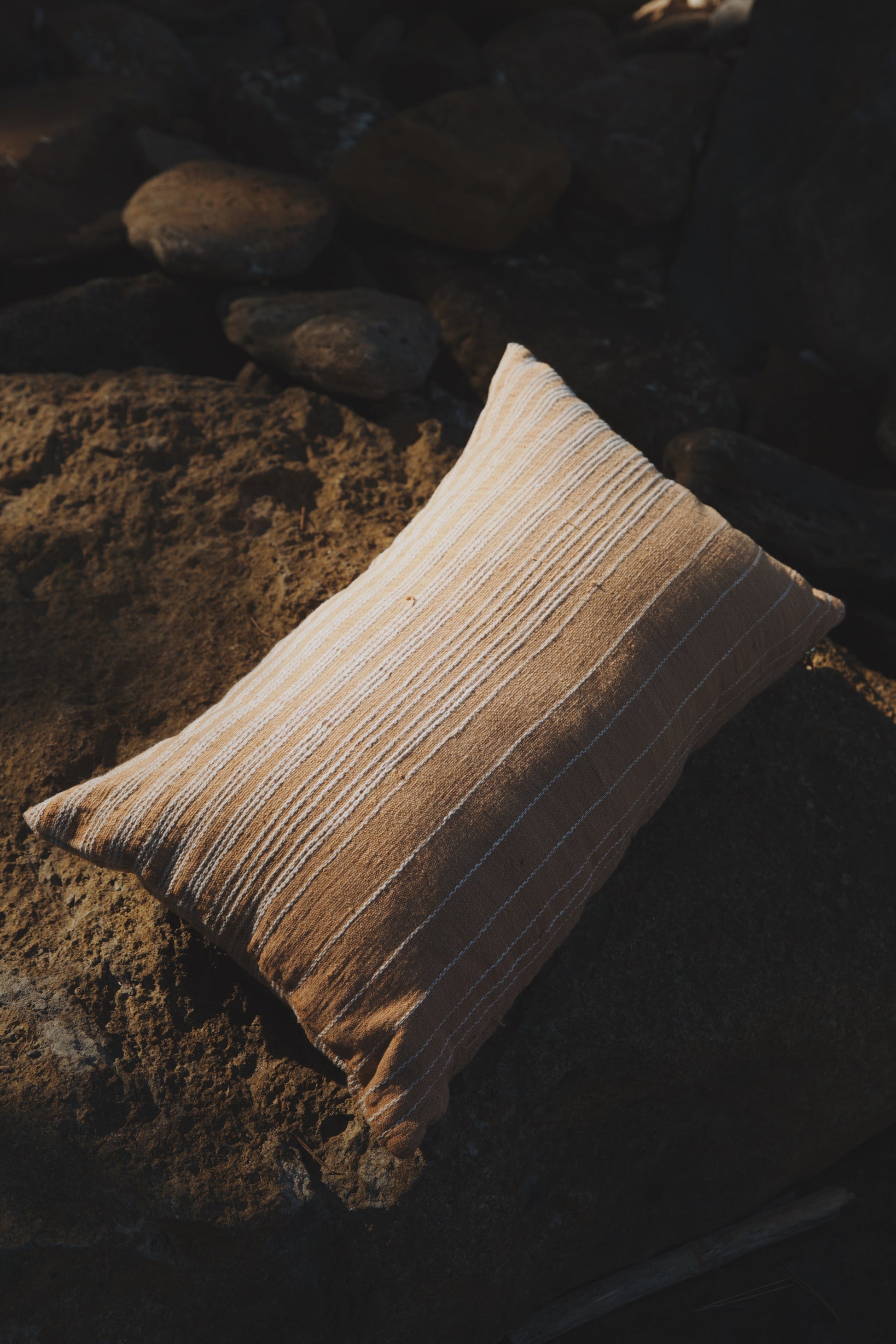 Textured pillow on a rocky surface