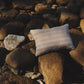 Striped pillow on a pile of rocks