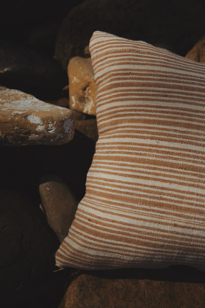 Striped pillow on a stone surface