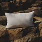 White pillow on a stone wall