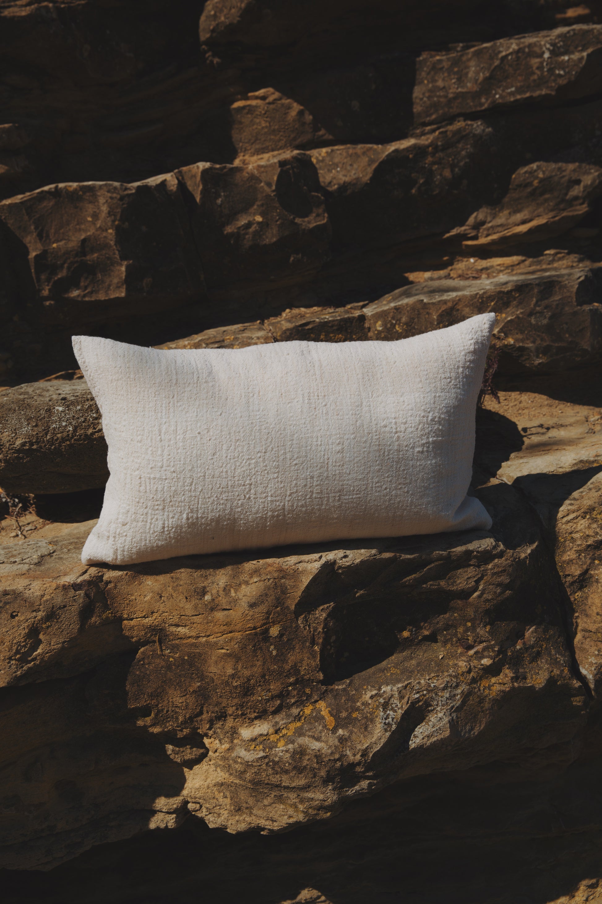 White pillow on a stone wall