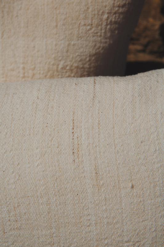 Close-up of textured beige fabric with a slight pattern