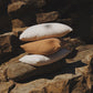 Stack of pillows on a stone wall
