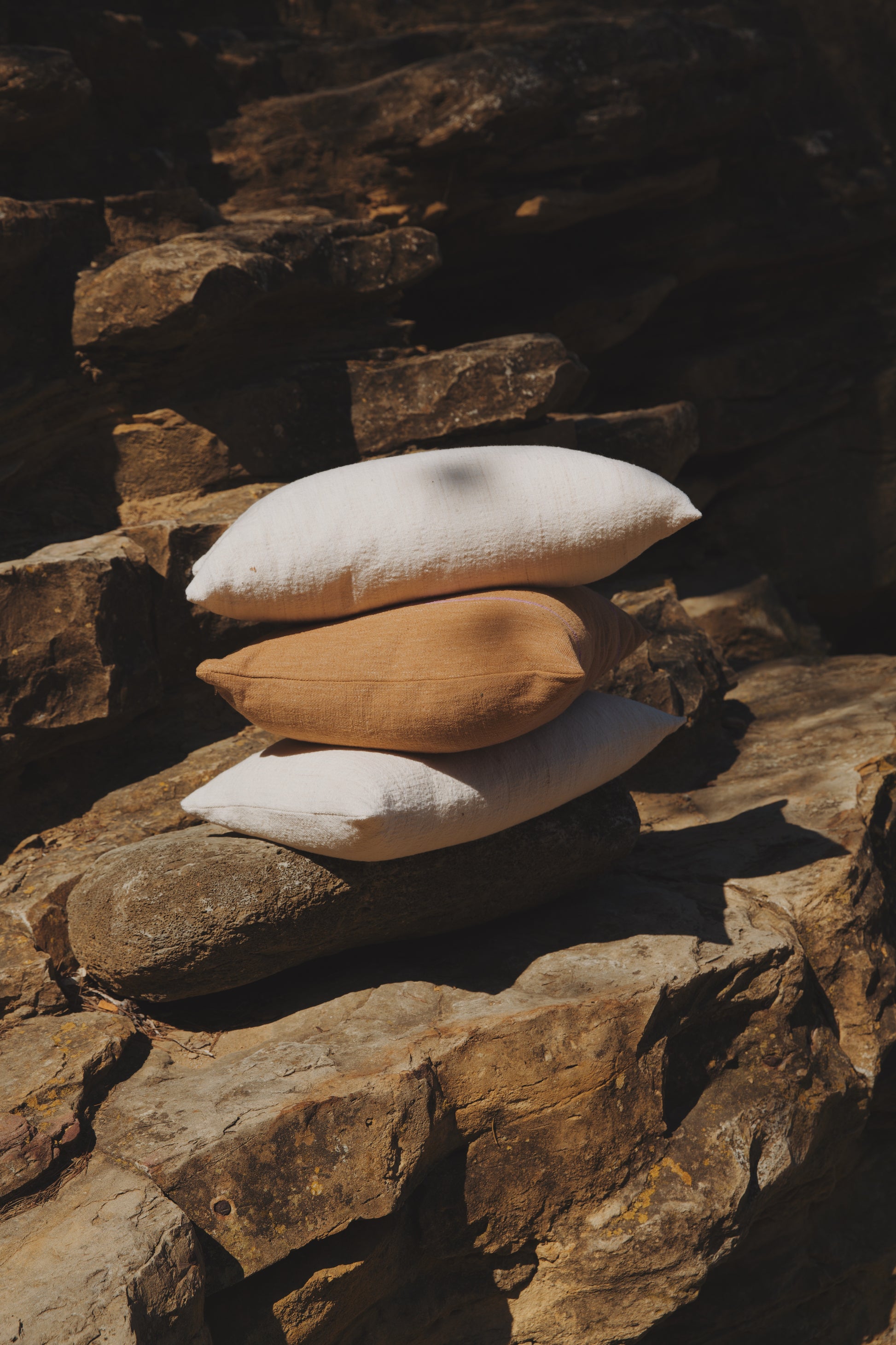 Stack of pillows on a stone wall