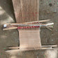 Handmade woven fabric on backstrap loom on a sandy surface
